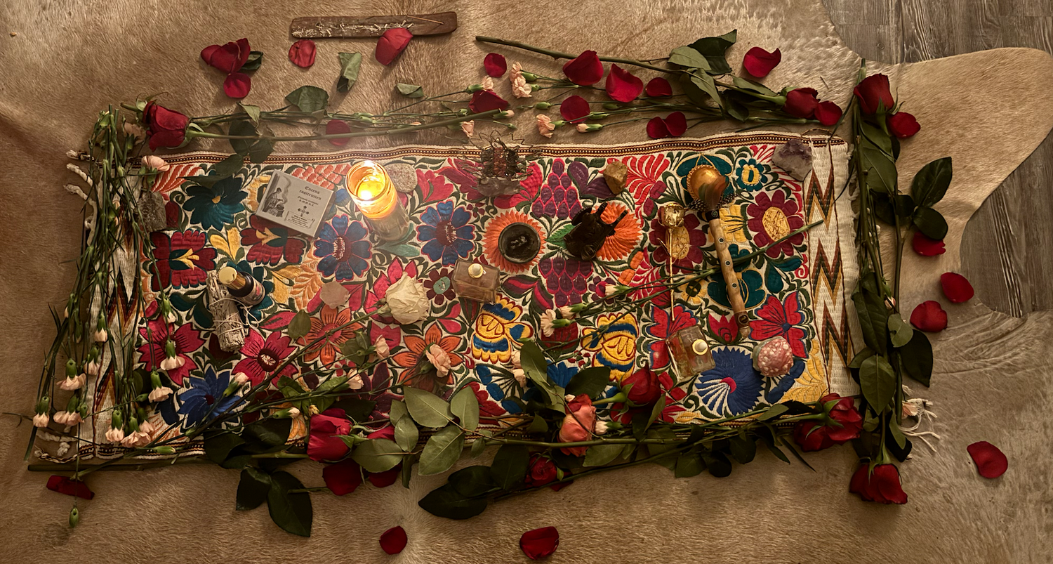 Multicolored alter adorned with roses, crystals, candles, oils and statues